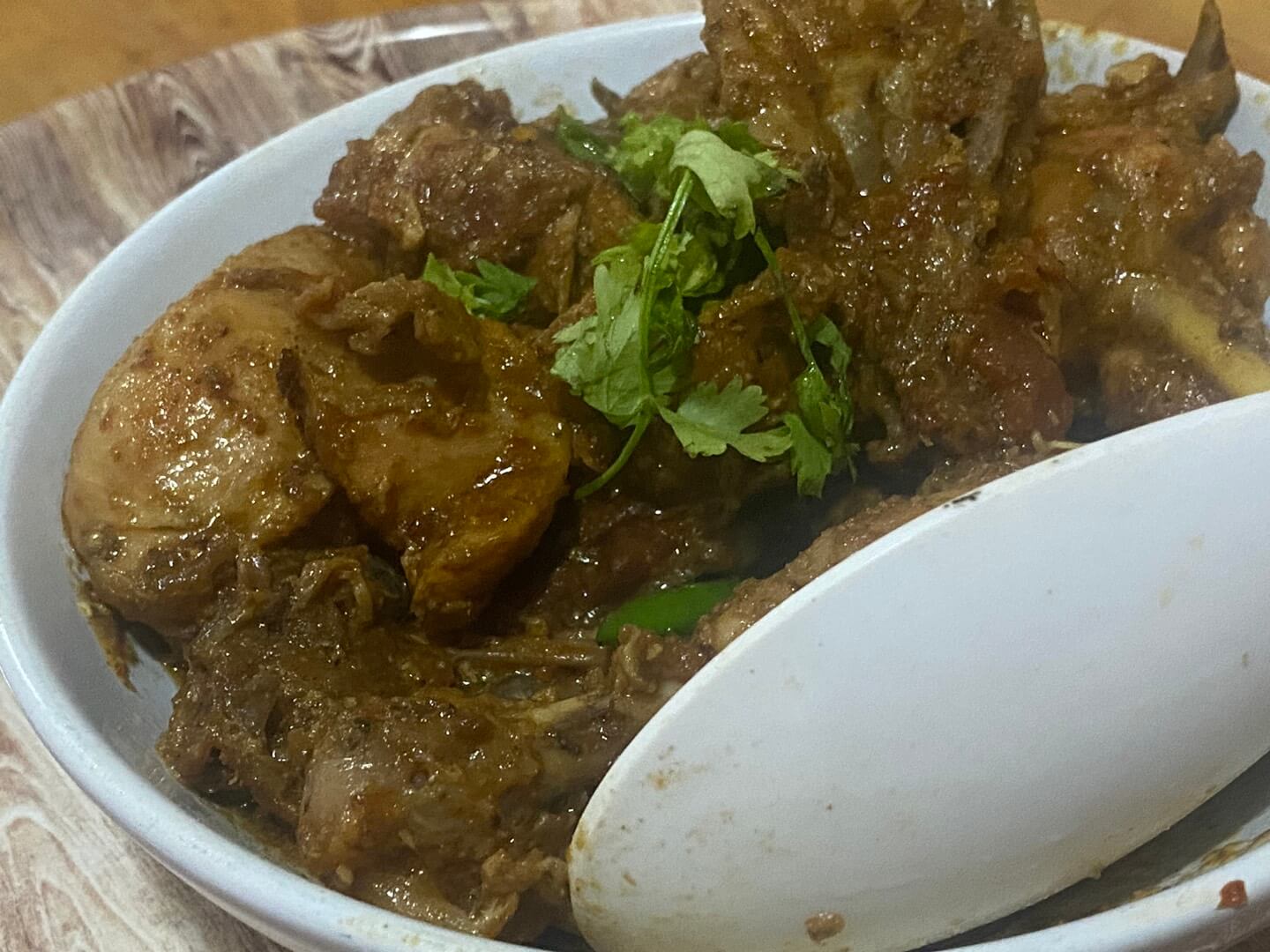 chickem karahi served in a white bowl
